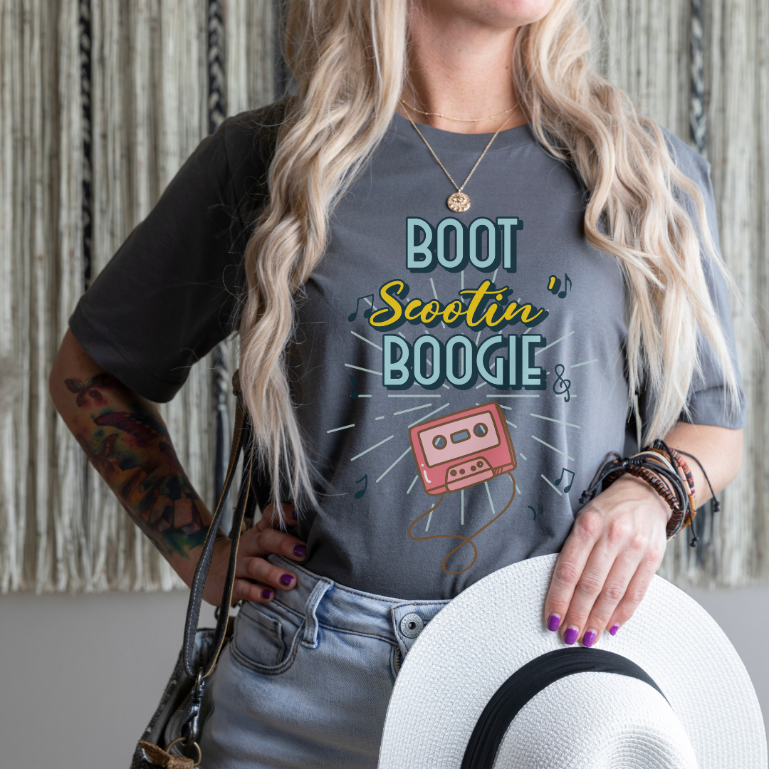 woman wearing a "boot scootin' boogie" t-shirt in the color asphalt