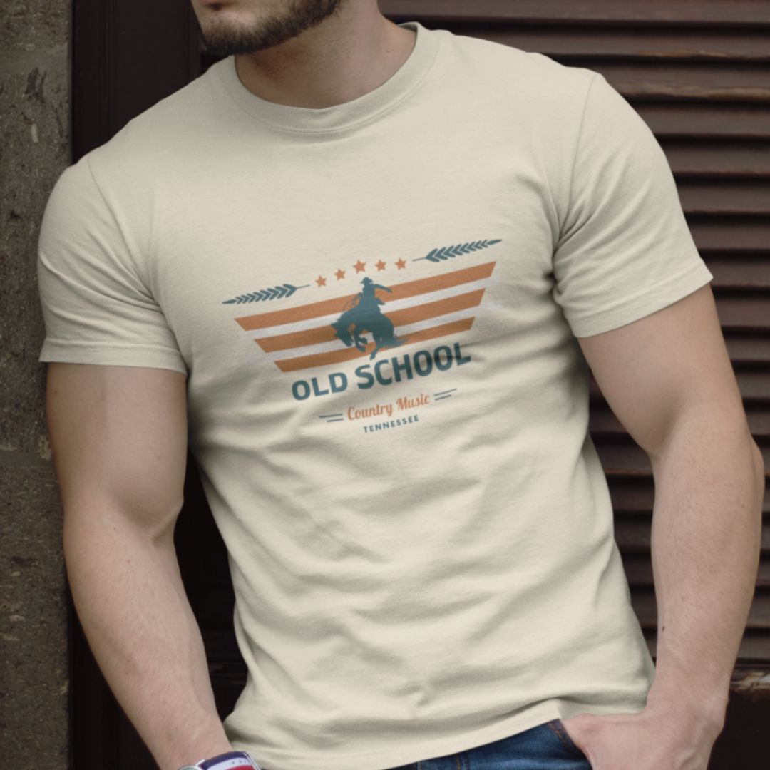 man wearing a t-shirt with "old school country" on it in the color natural.