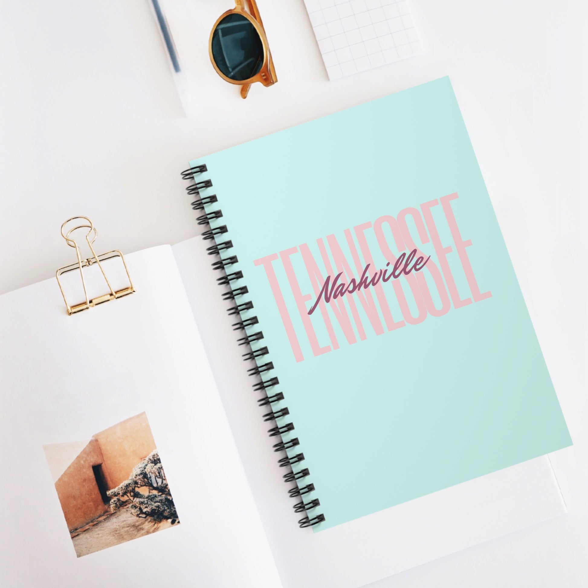 "Nashville, Tennessee" notebook in the color mint on a desk